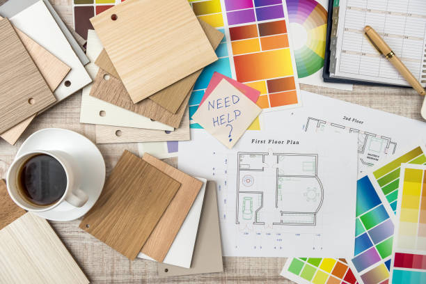 istock Colour palettes with house plan on desk top view. Designer working at new project 1196010972
