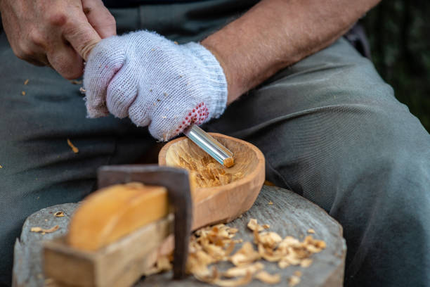 istock Craftsman demonstrates the process of making wooden spoons handmade using tools. National crafts concept. 1196011654