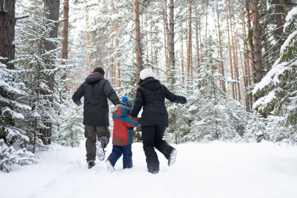 istock Family running in winter forest 1196012899