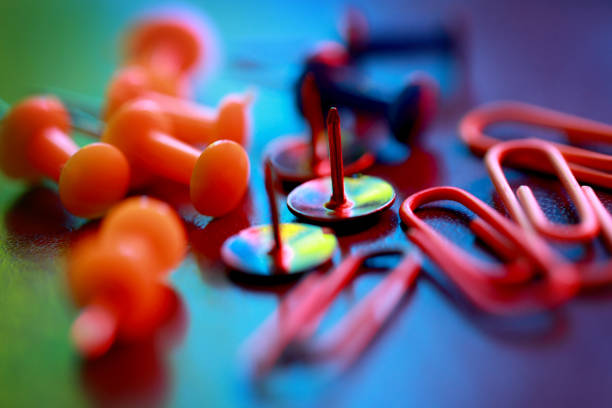 Close up of colorful pushpin and paper clips.