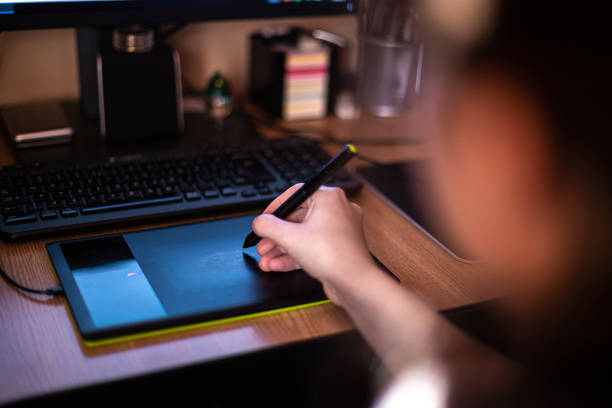 istock A person using graphic tablet with pen and working on new project idea 1196013136