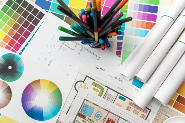 istock Colour palettes with house plan on desk top view. Designer working at new project 1196013233