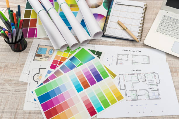 istock Colour palettes with house plan on desk top view. Designer working at new project 1196013879
