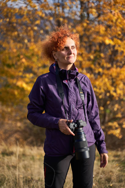 istock Woman with camera in the park 1196015089
