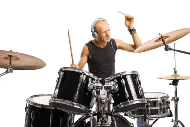 Photo of Male drummer with headphones playing a drum kit