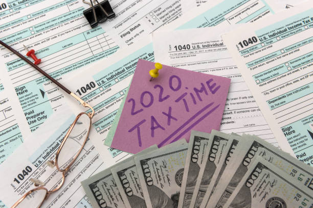 istock US tax form with money. 1196016142