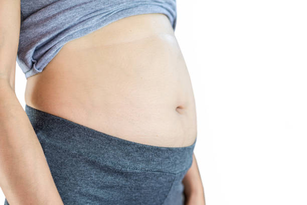 istock Pregnancy or overweight belly 1196016183