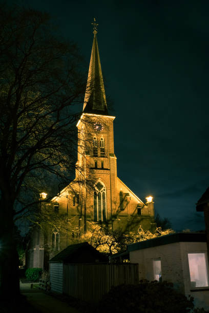 istock Catholic church in The Netherlands is illuminated at night 1196017243
