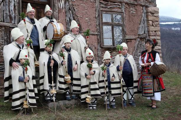 Koledari are Slavic traditional performers of a ceremony called koleduvane, a kind of Christmas caroling Gara Bov, Bulgaria - December 25, 2019: Festive holiday carols circumnavigate the houses of Bov village and sing Christmas songs. They wish the people from the village health, wealth and happiness. bulgarian culture photos stock pictures, royalty-free photos & images