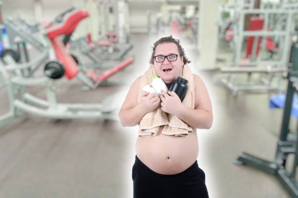 istock Diet and sport. Funny fat man. 1196017449