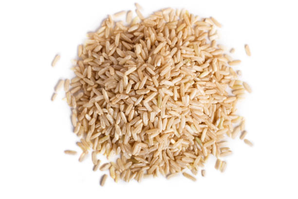 istock Pile of  brown rice isolated on white background.  Top view. 1196018049