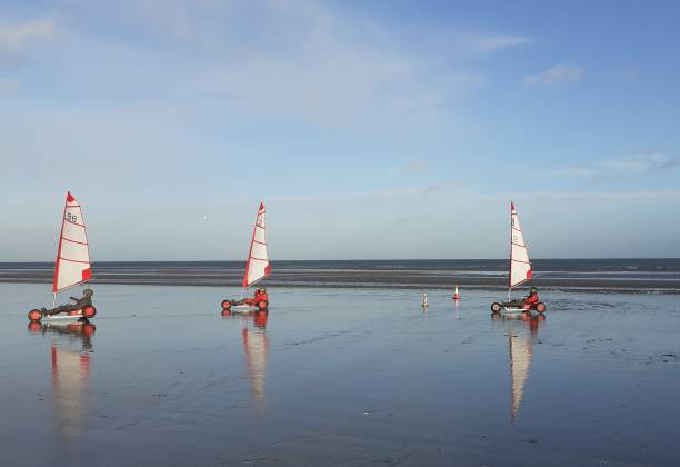 Kite buggies 15th December 2019, Meath, Ireland. Land sailing or yachting wind powered kite buggies on Bettystown Beach, reflected in the wet sand. cancale photos stock pictures, royalty-free photos & images
