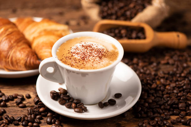 istock A cup of cappuccino with coffee bean as background 1196020661