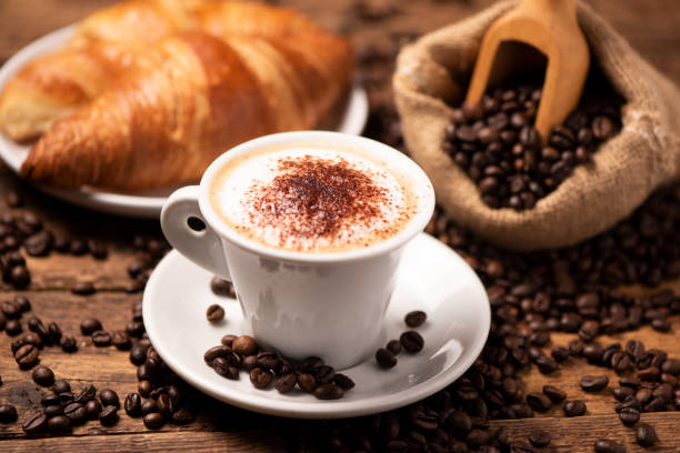 istock A cup of cappuccino with coffee bean as background 1196020695