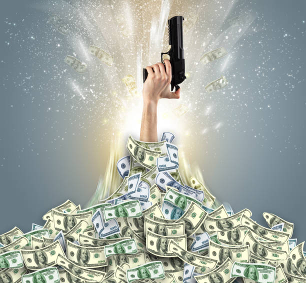 istock Hand bursting from a money heap 1196020811