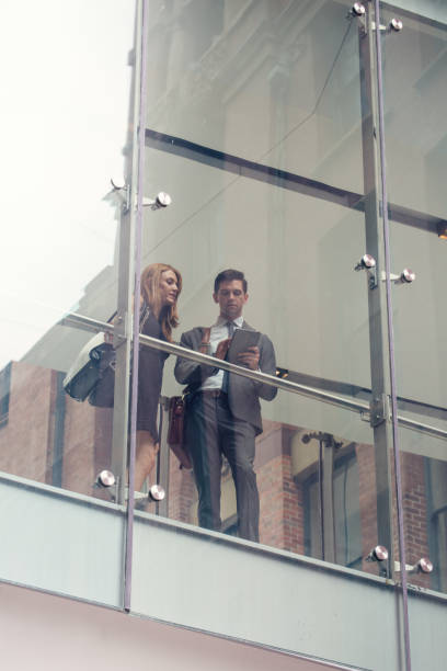istock Two business people on elevated wlakway 1196024054