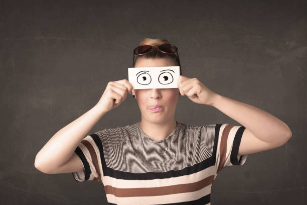 istock Funny woman looking with hand drawn paper eyes 1196026438