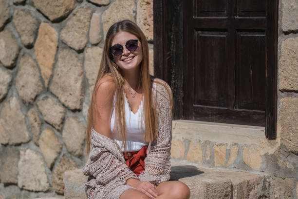 istock Young pretty women waiting old stone home 1196026456