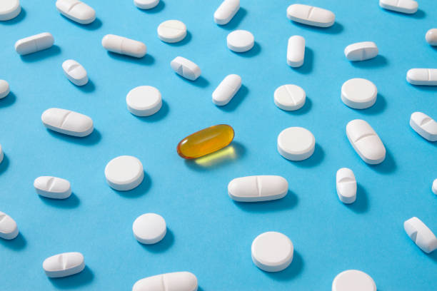 istock Fish Oil with Other Pills on Blue Background 1196027513
