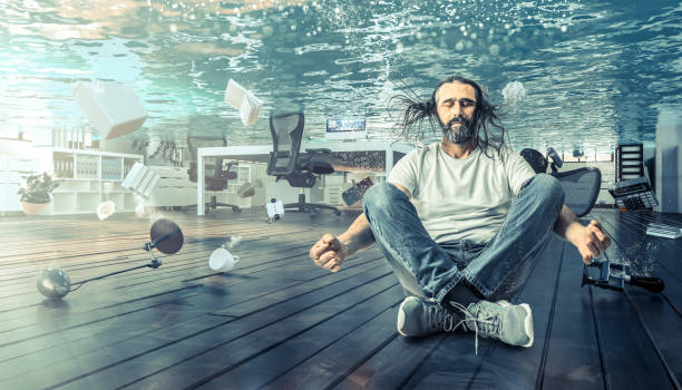 istock Digital Composite Of Man Sitting In Office Underwater 1196029511