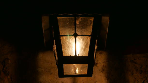 istock Decorative lamp on a old wall at night. 1196031732