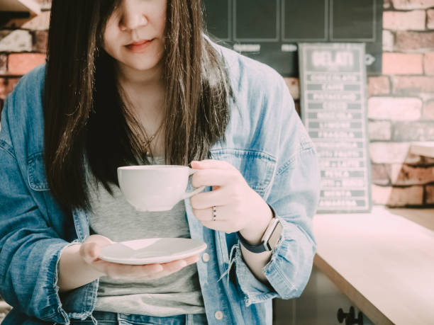 istock Midsection Of Woman Holding Coffee Cup 1196031878