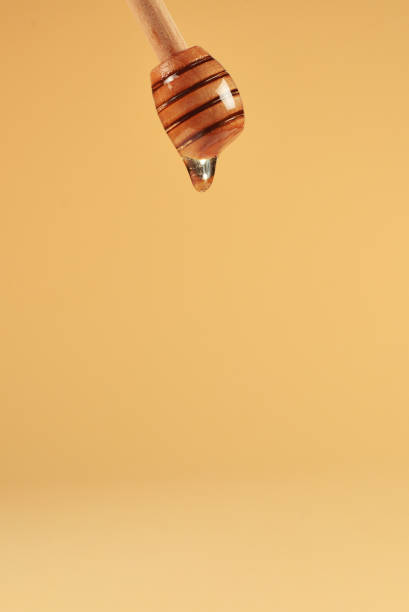 istock Dipper honey on orange background. Copy space. 1196032032