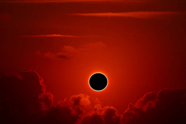 istock phenomenon of partial sun eclipse over silhouette orange cloud and sunset sky 1196032231