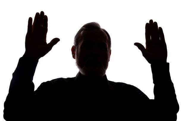 istock Hand old man covers his face, hands up - silhouette, concept 1196033090