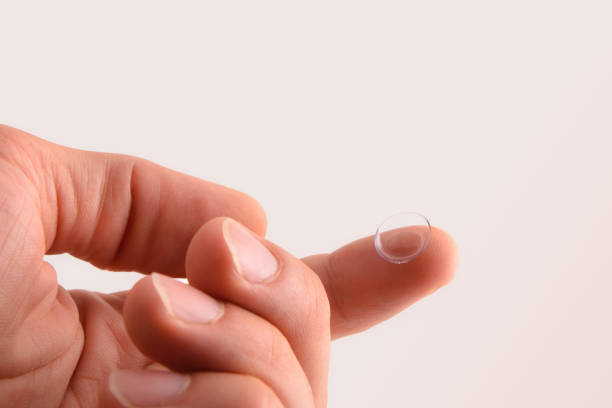 istock Hand with contact lens on finger with isolated background 1196034419