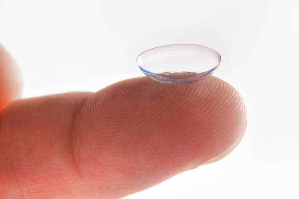 istock Finger detail with contact lens with isolated white background 1196034421
