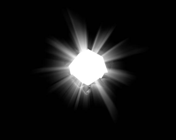 istock An isolated round hole in black paper with torn edges and piercing sunlight and rays through it. Sunlight breaking through the darkness from a hole. 1196035546