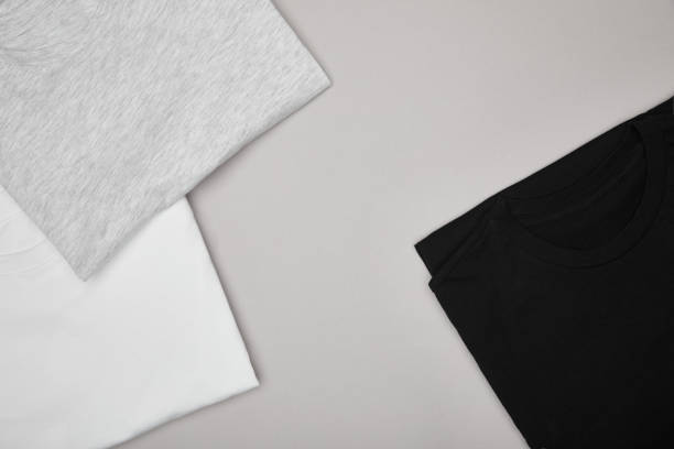 istock top view of blank basic black, white and grey t-shirts isolated on grey 1196037004