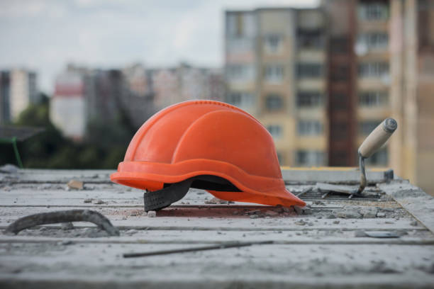 istock An orange helmet at Construction plant. People working on background. 1196039009