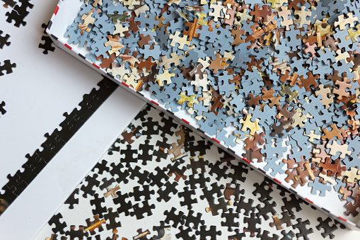 Mixed jigsaw puzzle pieces background, macro close up