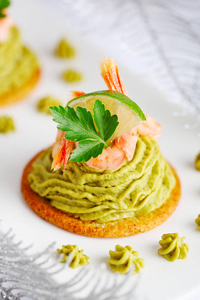 istock Avocado cream and prawns on crackers for Christmas 119604393