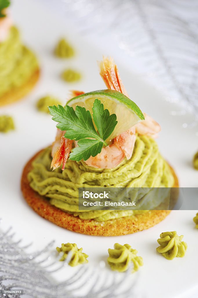 Avocado cream and prawns on crackers for Christmas  Appetizer Stock Photo