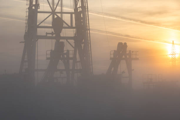 istock Fracking oil rig in the foggy morning 1196045032