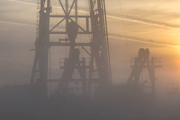 istock Fracking oil rig in the foggy morning 1196045049
