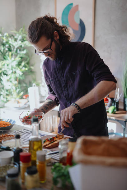 istock Chef serves sweet baked potatoes into plate 1196045570