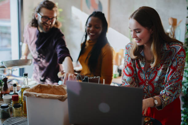 istock Friends using laptop to view cooking recipe 1196046181