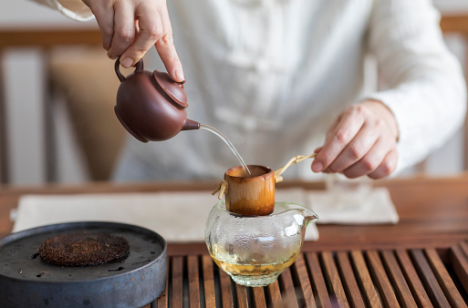 Woman serving Chinese tea in a tea ceremony.
