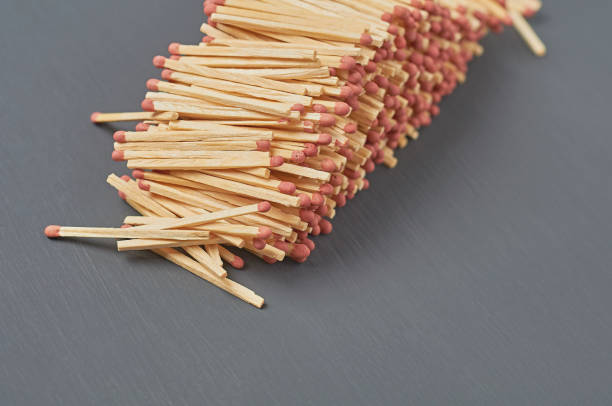 istock Heap of many new matchsticks with red head on dark concrete table on kitchen. Space for text 1196048517