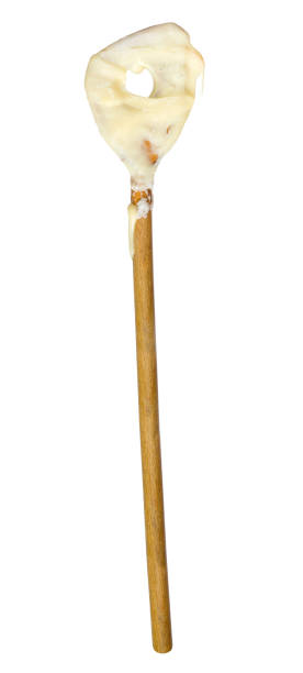 istock cake mixture on a wooden spoon, isolated on white background 1196048663