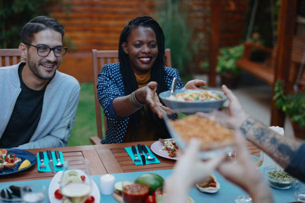 istock Friends enjoying vegan dinner together 1196049011
