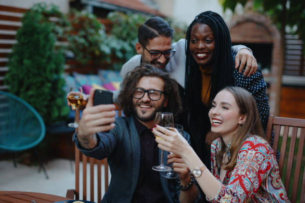 istock Smiling group of young people taking selfie while having dinner with friends 1196049589