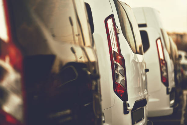 commercial VANs commercial VANs parked in row on dealership parking light commercial vehicle stock pictures, royalty-free photos & images