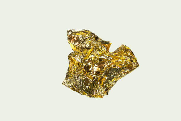 istock Folded paper sheet of gold isolated on white 1196053393