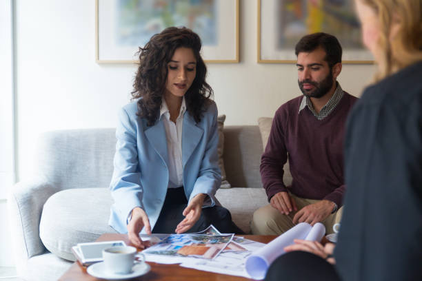istock Interior designer and clients discussing drawings 1196057854