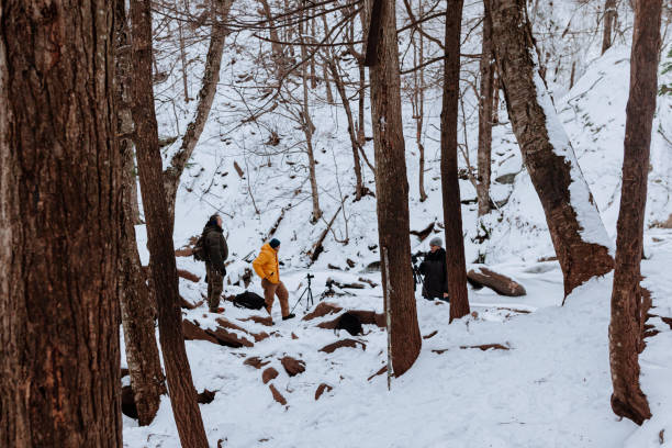 istock Photographers exploring a frozen waterfall 1196058873